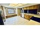 Bright eat-in kitchen boasts a window seat, white appliances, and ample cabinet space at 1670 Monterey Dr, Clearwater, FL 33756