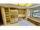 Spacious kitchen features wood cabinets, stainless refrigerator, and desk area at 1670 Monterey Dr, Clearwater, FL 33756