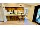 Open kitchen with wooden cabinets, stainless steel appliances, and breakfast bar seating at 1670 Monterey Dr, Clearwater, FL 33756