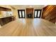 Spacious living room with fireplace, wood accents, new floors, and natural light through doors at 1670 Monterey Dr, Clearwater, FL 33756