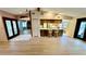 Spacious open concept living area with hardwood floors and view into the kitchen; great for entertaining at 1670 Monterey Dr, Clearwater, FL 33756