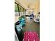 Screened-in patio with comfortable seating, ceiling fan, and views of the backyard at 1670 Monterey Dr, Clearwater, FL 33756