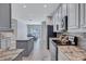 Kitchen with granite countertops, grey cabinets, tile backsplash, stainless steel appliances, and wood-look floors at 1778 Mira Lago Cir, Ruskin, FL 33570