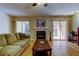 Cozy living room with fireplace and sliding glass doors to the patio at 2559 Stony Brook Ln, Clearwater, FL 33761