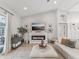 Bright living room featuring a modern fireplace, large ottoman, and neutral color palette at 2781 Jarvis Cir, Palm Harbor, FL 34683