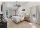 Spacious main bedroom featuring a ceiling fan, ensuite, and sliding glass door with a pool view at 2781 Jarvis Cir, Palm Harbor, FL 34683