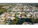 Aerial shot of waterfront home with pool, dock, and lush tropical landscaping at 4643 Bay Crest Dr, Tampa, FL 33615