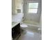 Bathroom with combination tub and shower, toilet, and built-in storage at 50 Acacia St, Clearwater Beach, FL 33767