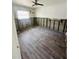 Empty bedroom with ceiling fan and hardwood flooring undergoing renovation at 50 Acacia St, Clearwater Beach, FL 33767