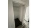 Small, empty closet with dark floor and an upper shelf at 50 Acacia St, Clearwater Beach, FL 33767