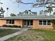 Front exterior of a well-kept single-story home featuring a neat lawn and tidy landscaping at 50 Acacia St, Clearwater Beach, FL 33767