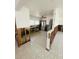 Open kitchen featuring stainless steel refrigerator, sink, and vintage tile flooring at 50 Acacia St, Clearwater Beach, FL 33767