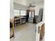 Spacious kitchen with tile floor, stainless steel refrigerator, sink, and large window at 50 Acacia St, Clearwater Beach, FL 33767