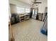 Bright kitchen area with modern appliances, window, and vintage tile flooring at 50 Acacia St, Clearwater Beach, FL 33767