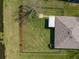 Aerial view of a home with a large green yard, black fence, and screened in porch at 5249 Moon Shell Dr, Apollo Beach, FL 33572