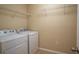 Well-equipped laundry room with a washer and dryer, complete with wire shelving at 5249 Moon Shell Dr, Apollo Beach, FL 33572