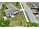 An aerial view showcases this single-story home and its expansive yard and quiet neighborhood at 5729 13Th St, Zephyrhills, FL 33542