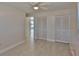 Bedroom featuring a ceiling fan, tile floors, base trim, and dual-door closets at 5729 13Th St, Zephyrhills, FL 33542