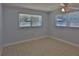 Bedroom with tiled floors and two large windows at 5729 13Th St, Zephyrhills, FL 33542
