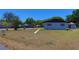 Exterior shot of single-Gathering home with a large front lawn at 5729 13Th St, Zephyrhills, FL 33542