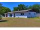 Exterior of a single-story home with well kept yard and landscaping at 5729 13Th St, Zephyrhills, FL 33542