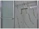 Close up of shower featuring niche, accent tile, and glass doors at 5729 13Th St, Zephyrhills, FL 33542