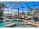 Inviting pool area with sun loungers, screened enclosure, and waterfront views at 621 Balibay Rd, Apollo Beach, FL 33572