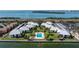 Aerial view of waterfront community featuring multiple buildings and a central swimming pool at 7300 Sunshine Skyway S Ln # 202, St Petersburg, FL 33711
