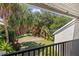 Relaxing balcony view overlooking lush green landscaping and mature trees at 7300 Sunshine Skyway S Ln # 202, St Petersburg, FL 33711