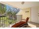 Enjoy outdoor living on this cozy balcony with chairs and pleasant surroundings at 7300 Sunshine Skyway S Ln # 202, St Petersburg, FL 33711
