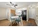 Dining area with a table, four chairs, a ceiling fan and a view to the kitchen at 7300 Sunshine Skyway S Ln # 202, St Petersburg, FL 33711