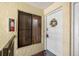 Condo entryway featuring front door with wreath and a window with closed blinds at 7300 Sunshine Skyway S Ln # 202, St Petersburg, FL 33711
