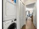 Conveniently located stacked washer and dryer with nearby storage and access to bedroom at 7300 Sunshine Skyway S Ln # 202, St Petersburg, FL 33711