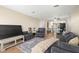 Open-concept living room flowing into dining area and kitchen, wood floors and a sofa at 7300 Sunshine Skyway S Ln # 202, St Petersburg, FL 33711