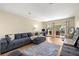 Spacious living room with wood flooring, large couch, and sliding doors to balcony at 7300 Sunshine Skyway S Ln # 202, St Petersburg, FL 33711