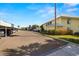 Exterior shot of a condo complex parking lot with assigned covered parking and landscaping at 7300 Sunshine Skyway S Ln # 202, St Petersburg, FL 33711