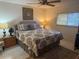 Comfortable bedroom features a ceiling fan, area rug, and bedside tables with lamps at 9337 Zamora Dr, New Port Richey, FL 34655