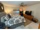 Carpeted bedroom features ceiling fan, area rug, dresser, and television at 9337 Zamora Dr, New Port Richey, FL 34655