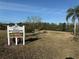 Riverside Villas, welcome to Riverside Park community sign with flamingo image and park bench overlooking a pond at 9337 Zamora Dr, New Port Richey, FL 34655