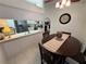 Dining area with a decorative clock, wood table and four chairs next to the kitchen at 9337 Zamora Dr, New Port Richey, FL 34655