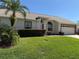 Single story home with manicured lawn, landscaping, and a two-car garage at 9337 Zamora Dr, New Port Richey, FL 34655