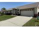 Lovely single-story home with a paved driveway, lush lawn, and attached two-car garage at 9337 Zamora Dr, New Port Richey, FL 34655