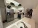 Modern kitchen with stainless steel appliances, white cabinets, and a double sink beneath skylights at 9337 Zamora Dr, New Port Richey, FL 34655