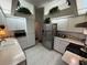 Clean kitchen features a sink, oven, microwave and stainless-steel refrigerator at 9337 Zamora Dr, New Port Richey, FL 34655