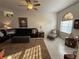 Comfortable living room featuring tile floors, a ceiling fan, and a large sofa at 9337 Zamora Dr, New Port Richey, FL 34655
