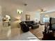 Inviting living room with tile floors, ceiling fan, and an open layout at 9337 Zamora Dr, New Port Richey, FL 34655