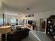 Inviting living room with tile floors, ceiling fan, front door, and a comfortable seating area at 9337 Zamora Dr, New Port Richey, FL 34655