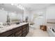 Bathroom featuring double vanity with granite countertop and decorative touches at 11616 Little River Way, Parrish, FL 34219