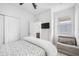 A bright bedroom with a ceiling fan, large closet, and a chair at 11616 Little River Way, Parrish, FL 34219