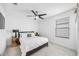 Bright bedroom featuring neutral walls, ceiling fan, and an upholstered headboard at 11616 Little River Way, Parrish, FL 34219